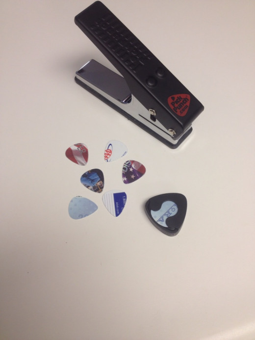 The Pick Punch and some "punched" out guitar picks.