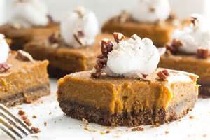 pumpkin pie squares with dollop of whipped cream and nuts