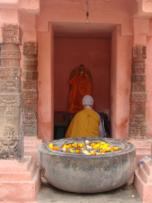 Monk Prays At A Shrine Outside Mahabodhi Temple