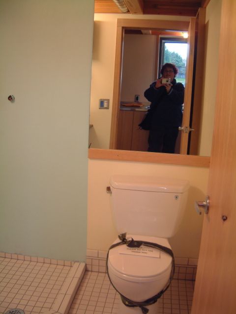 This shot of me in the bathroom mirror shows a toilet, and the shower corner.