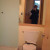 This shot of me in the bathroom mirror shows a toilet, and the shower corner.