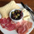 The charcuterie plate can even be a meal, with crackers, veggies/pickles and exotic meats accompanying the cheeses.