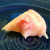 This is a sheet of rice dough, folded around a filing of pink, sweet bean paste.