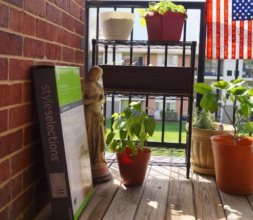 One shelf assembled and next to the rail.  Testing the sizes of my planters.