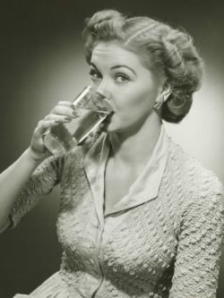 Woman Drinking Water From Tall Glass