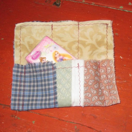 Tissue holder using selvage fabric.