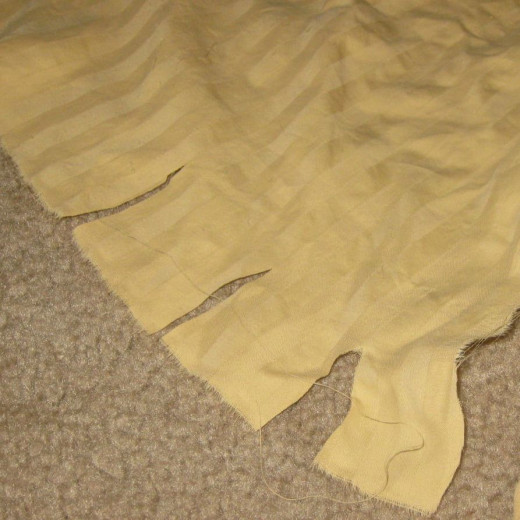Cut notches in the fabric to begin making fabric strips.