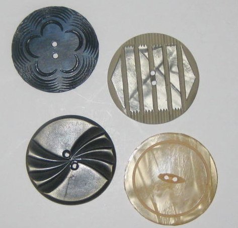 These large decorative sewing buttons are carved shell and plastic.