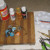Craft supplies needed: bottle caps, wire, craft paint, paintbrush, Mod Podge, center hole punch, wire cutter, flat nose pliers, round nose pliers. Craft supplies needed: bottle caps, wire, craft paint, paintbrush, Mod Podge, center hole punch, wire cutter, flat nose pliers, round nose pliers.