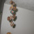 Punch holes in bottle caps to make a rustic wind chime. String illusion cord (clear fishing line works too!) to string them together. Punch holes in bottle caps to make a rustic wind chime. String illusion cord (clear fishing line works too!) to string them together.