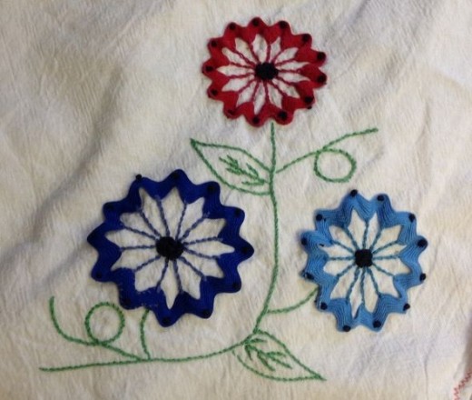 Vintage tea towel with rick rack flowers.