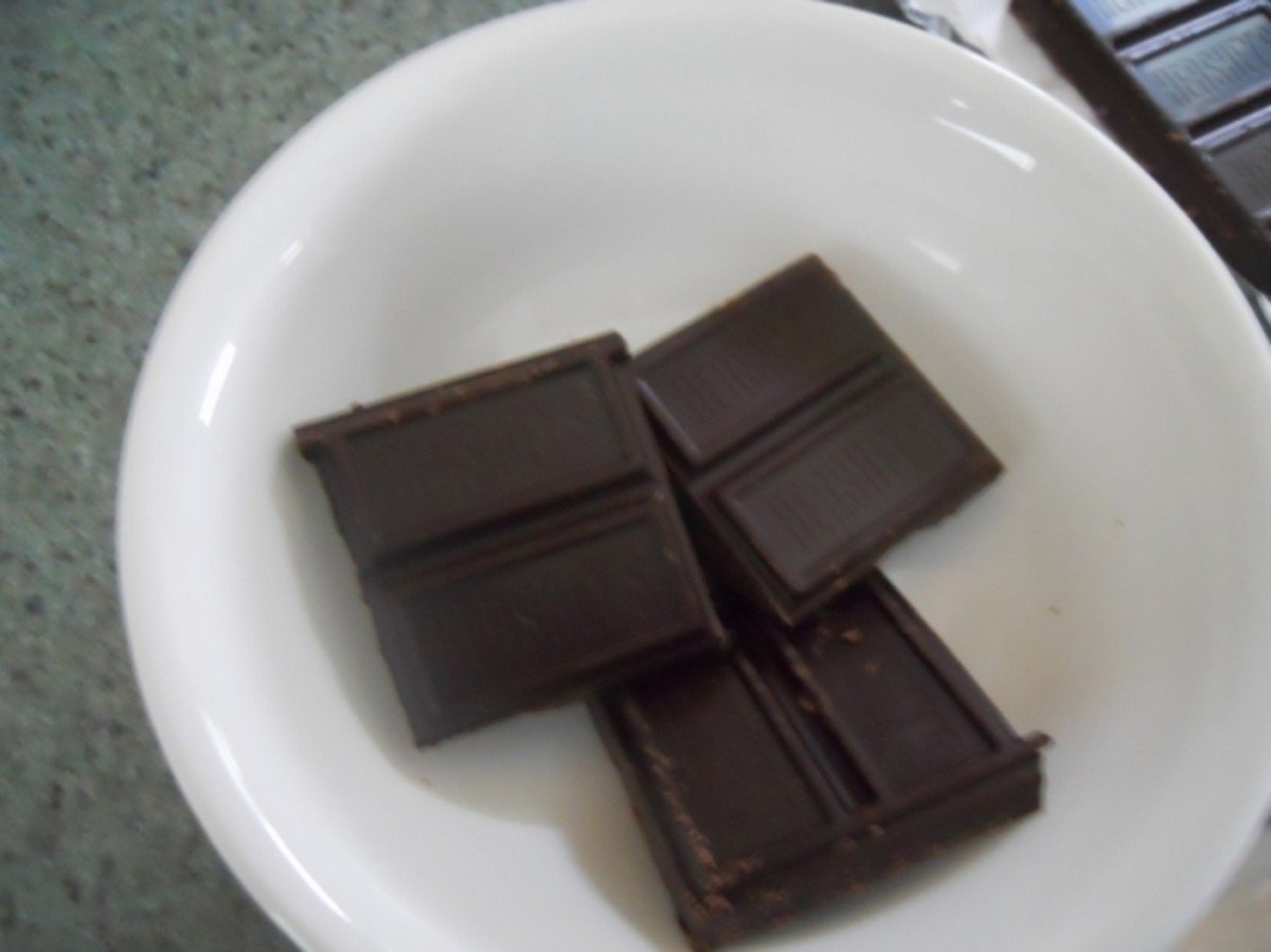 Break half the candy bar into 4 pieces and place in a microwave safe dish.   Microwave for 2 minutes.