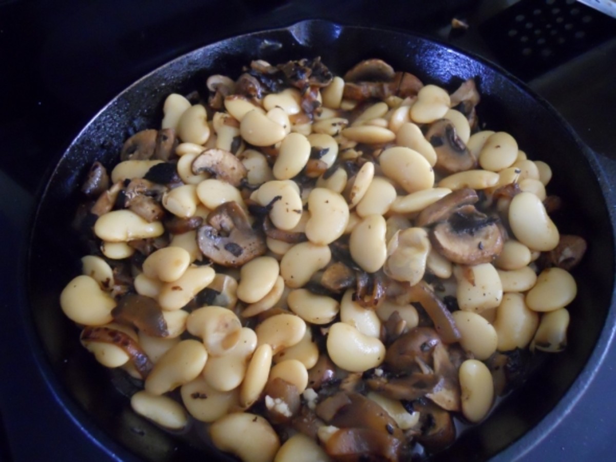 Add beans, nutmeg, salt and pepper to the mixture.   Stir.   Heat until simmering.   About 5 minutes.