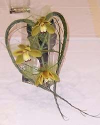Heart-shaped contemporary bridal bouquet displayed in a vase 