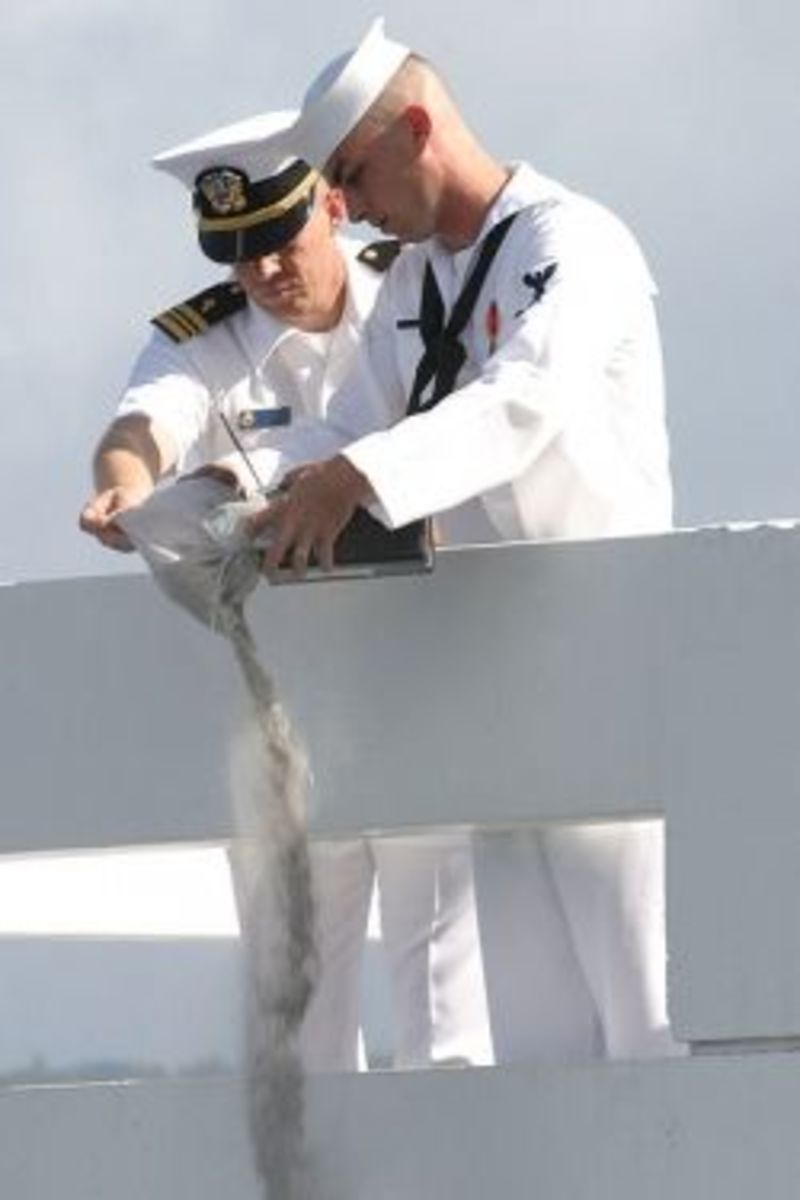 US Navy 030830-N-3228G-005 Cryptologic Technician Operator 3rd Class Evan Allen, assigned to the amphibious assault ship USS Peleliu (LHA 5) pours the cremated remains of his grandfather Darrell Allen, a Pearl Harbor survivor