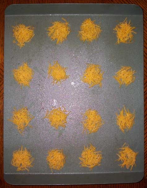 Shredded cheese mounds on baking sheet