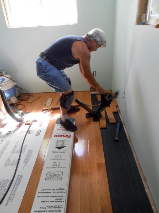 Hubby is installing the new hardwood flooring.