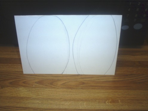 Fit two egg shapes onto a folded card.