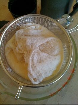 Wrap the ends of the cheesecloth over the top of the yogurt; walk away and let gravity do its job for an hour or two.