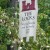 A banner in the midst of more flowering shrubs