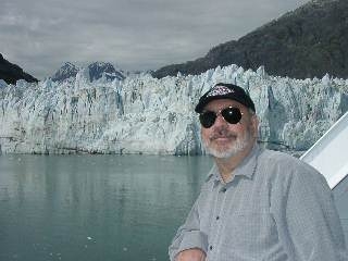 This photo of my husband, taken on the balcony of our room on the ship, will give you some idea of the size of the glaciers.  The ship was over 1 mile away from the glacier you see in the background.