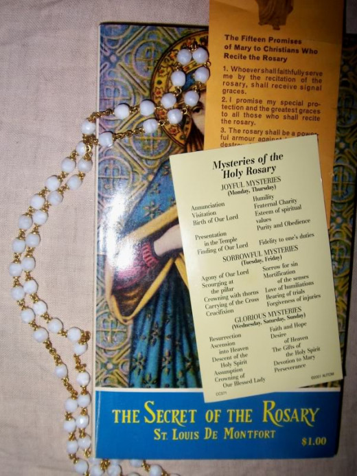 Rosary, book on the rosary, and cards explaining the rosary