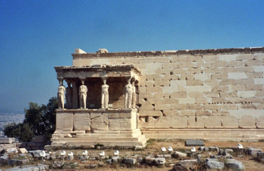 South side of the Erechtheion, "Porch of the Maidens," facing the Parthenon. The karyatids (human-shaped-columns) are replicas; the originals are in museums to protect them.