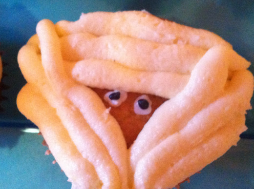 Mummy cupcakes from the book. Made last minute, so plain rather than chocolate, and I used the wrong piping tip so the bandages were a tad too thick! Mummy cupcakes from the book. Made last minute, so plain rather than chocolate, and I used the wrong piping tip so the bandages were a tad too thick!