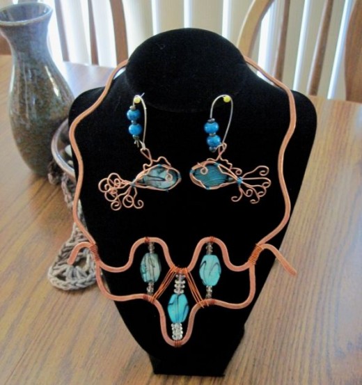 Copper hammered wire with teal blue green shell fish earrings to match