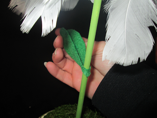 Then I wrapped it around the dowel and hot glued the sides together with the pipe cleaner in the middle. Repeat with second leaf have one stick out to the left and the other to the right of the dowel rod. Make sure they are far enough down the dowel 