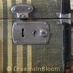 A broken latch on an old suitcase