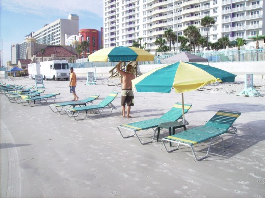 While the tourists remain nestled snugly within the towering timeshares, crews begin setting up tents and chairs.