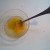 Break the yolk and mix it up with the fork. When done mixing rinse the fork off for future use.
