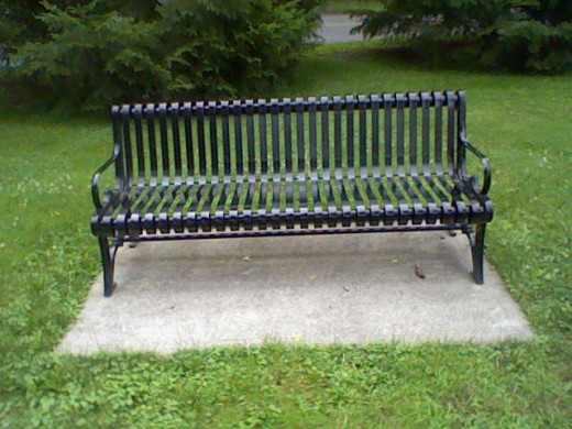 A bench under a tree or in the shade.