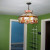 Old lighting fixture in living room. View towards doorways to kitchen (right) and living room (left). Old lighting fixture in living room. View towards doorways to kitchen (right) and living room (left).
