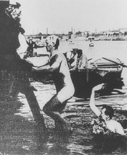 Gold Medal Winning Australian Frederick Lane climbing out of the river after competing in the 1900 Paris Olympics' swimming obstacle race.