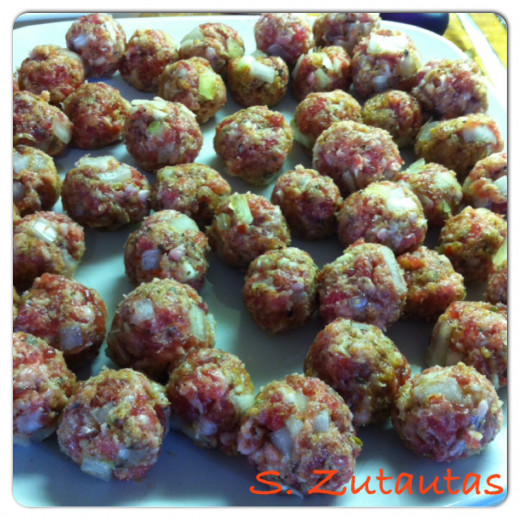 Meatballs are made, set on a plate, and set aside or refrigerate until ready to use.