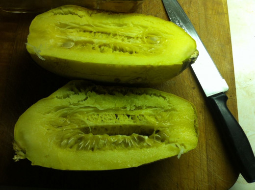 Once the squash has come out of the oven slice it in half lengthwise.