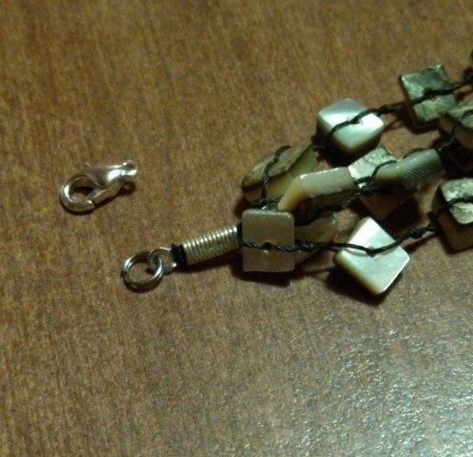 Remove the old lobster-claw clasp. I used split rings in the original design, so I just left them on this bracelet.