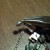 Slide one end of the chain and the magnetic clasp onto the split ring - like sliding keys onto a key ring. Repeat for the other end.