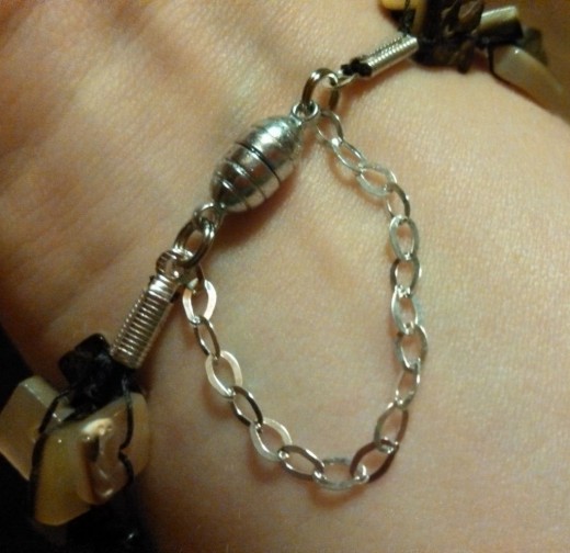 When the clasp is not stuck together, the bracelet with the added length of chain slips easily over the hand. Pull the clasp together and presto!