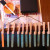 Clip bare ends of sticks to a clothes hanger to dry while you paint more sticks. Clip bare ends of sticks to a clothes hanger to dry while you paint more sticks.