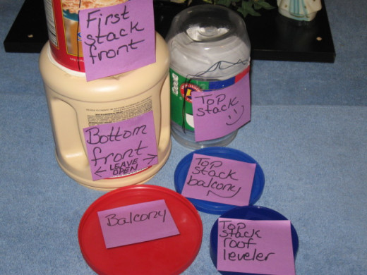 The structural components of the tower consist of 1 empty coffee creamer container, 1 empty Jiffy Peanut butter container (crunchy), and one oatmeal container with lids.