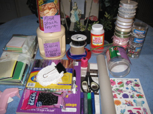 The finishing touches are mostly non-adhesive shelf paper, doilies, napkins, paper, temporary tattoos, 4 crafting sticks and ribbon.