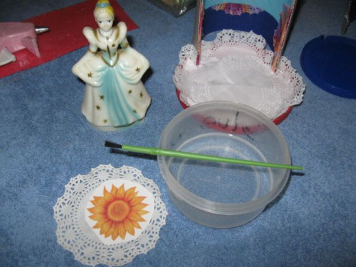 Use temporary tattoos to decorate doilies for flooring on the balconies. Just cut it out. Remove the covering. Place it face down on the doily. Wet it really good. Hold and rub, rub, rub. Peel off the backing.