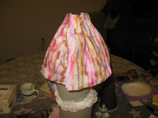 When dry, about five to ten minutes, fold the top of the napkins in a fan. Glue down to the rafters.