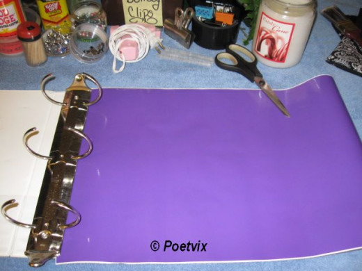 Begin by covering each inside cover of the three ring binder. Mine was old, abused, permanently scratched and coming apart on the spine. It was either find a way to fix it, or trash it.