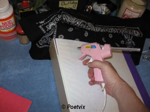 After clipping across the top, flip the bandanna up. Start gluing it down. Work in rows about an inch or two apart. Be really generous with the glue, especially on the sides.