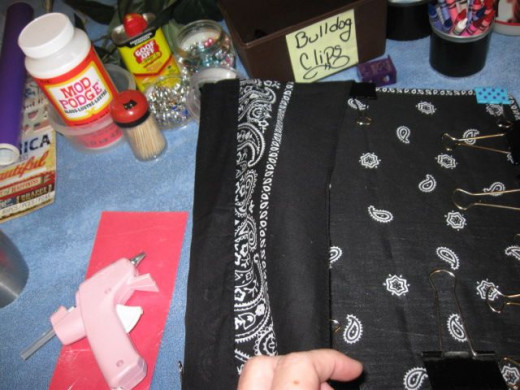 If you want the border, like I did, fold the bandanna back over onto itself. There is a good bit of fabric left after the spine depending on how you arrange it.A WORD ABOUT THE GLUE - You will see some spots where the glue seems to discolor the fabri