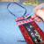 String a thin piece of coordinating ribbon through the hole. Tie it off at the top. I had a small open spot right by the hole I punched for the ribbon, so I painted it in with the melted blue crayon. It did not take much. String a thin piece of coordinating ribbon through the hole. Tie it off at the top. I had a small open spot right by the hole I punched for the ribbon, so I painted it in with the melted blue crayon. It did not take much.
